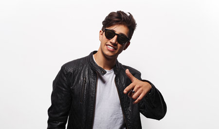 Cool young man pointing forward