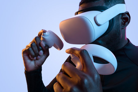 Young black male gamer using VR controller in studioの写真素材