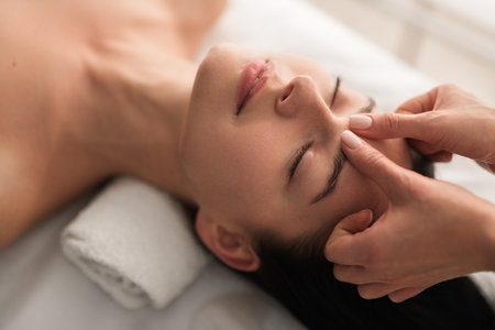 Crop masseuse doing massage to clientの写真素材