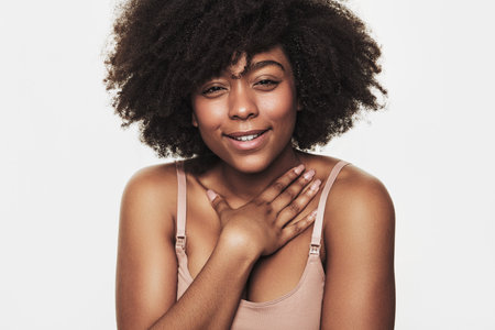 Thankful black woman touching chestの写真素材