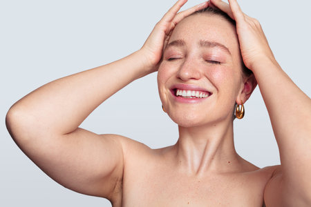 Cheerful woman with closed eyesの写真素材