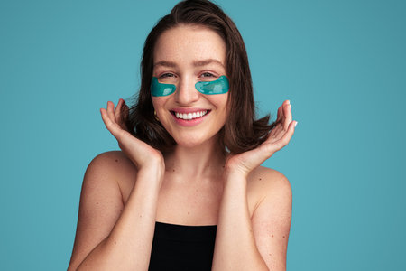 Smiling woman with eye patches