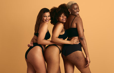 Diverse plus size women hugging in studioの写真素材