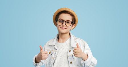 Stylish boy showing thumbs up gestureの写真素材
