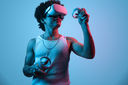 Man in VR headset playing videogame with controllers