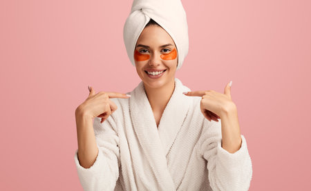 Content young lady with eye patches pointing at herself and smilingの写真素材
