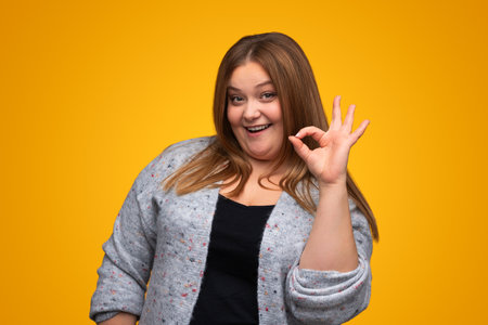 Plus size woman showing OK gestureの写真素材