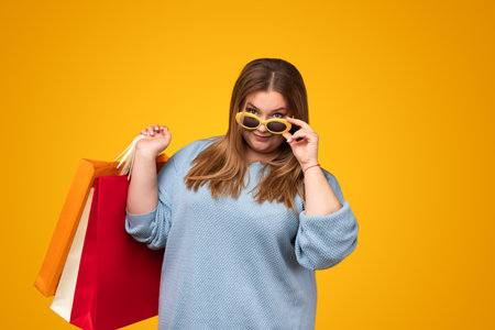 Plus size woman with paper bagsの写真素材
