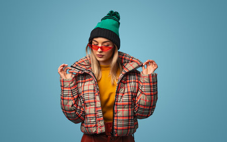 Stylish woman in warm jacket and sunglassesの写真素材