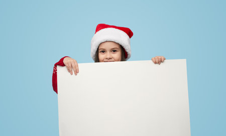 Excited boy in santa hatの写真素材