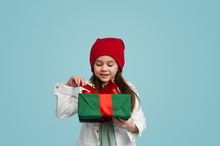 Smiling woman with red gift boxの写真素材