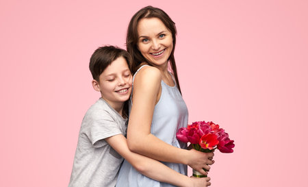 Woman with boy having holiday bouquetの写真素材