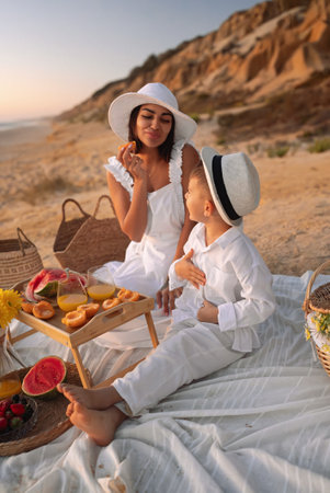 Mother and Son Enjoying a Beach Picnic Togetherの写真素材