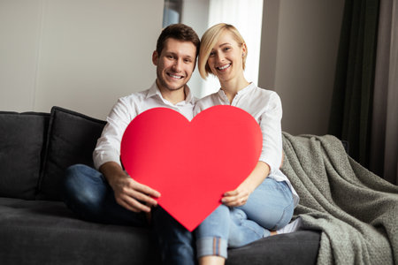 Couple Holding a Heart Symbol to Express Love and Togetherness