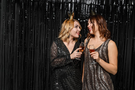 Two Women Celebrating Together at a Festive New Year Partyの写真素材