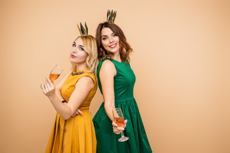 Women in Elegant Dresses Celebrating Together With Glasses of Sparkling Wineの写真素材
