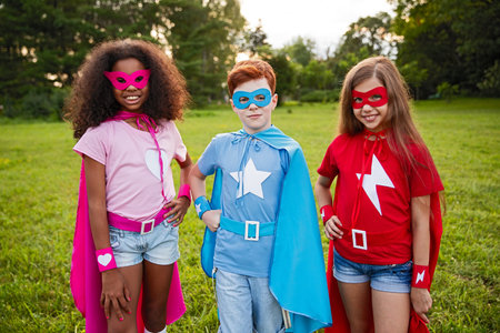 Group of Kids Dressed as Superheroes Standing Outdoors in a Parkの写真素材