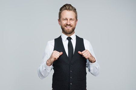 Confident Business Professional Smiling Wearing Elegant White Shirt and Vestの写真素材