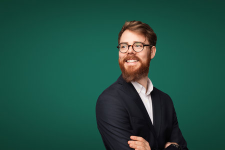 Smiling Professional Bearded Man in Suit with Green Backgroundの写真素材