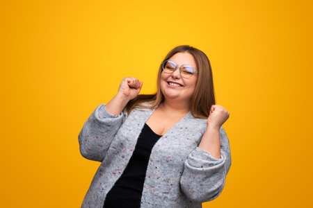 Excited plus size woman rejoicing over successの写真素材