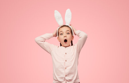 Excited girl in white ears screaming happilyの写真素材