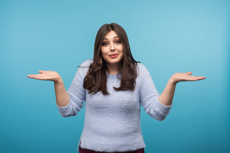 Confused Woman Gesturing with Hands on Blue Background