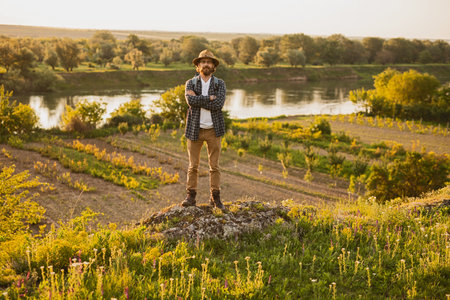 Farmer Enjoying Sunset in Rural Countryside With Scenic Landscapeの写真素材