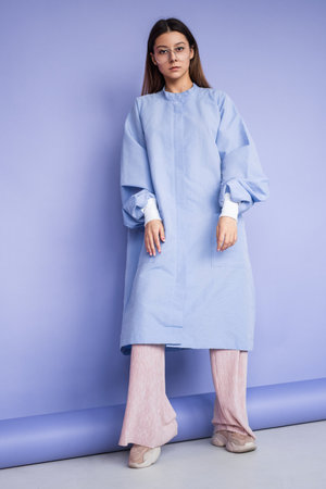 Trendy Woman in Minimalist Fashion Against Stylish Monochromatic Backgroundの写真素材