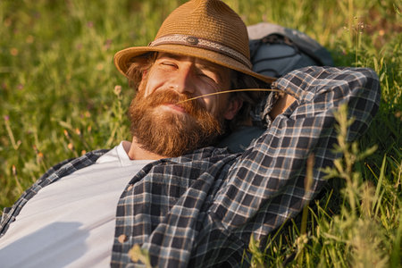 Relaxed Man Enjoying Nature in a Sunny Field With Warm Smiles Outdoorsの写真素材