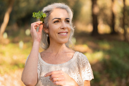Joyful Woman Smiling Outdoors Embracing Nature and Positivity in Sunshineの写真素材