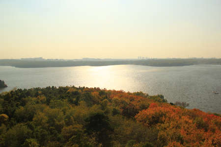 Height overlooking the lake and mountains under the sunの写真素材