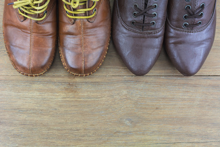 Shoes men and women active in daily life./ Shoes on the wooden floor.の写真素材