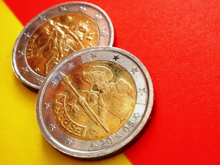 2-euro coins: Spain and Europe: In the foreground is the Spanish 2-euro coin with Don Quixote lying on the Spanish colors red and yellow, in the background the Europe of the Greek coin.の写真素材