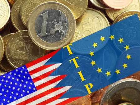 TTIP American and European flag in front of a pile of euro coinsの写真素材