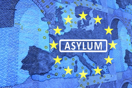 Asylum in Europe -On the map of Europe is the lettering ASYLUM. Surrounded by the European Circle of Stars.の写真素材
