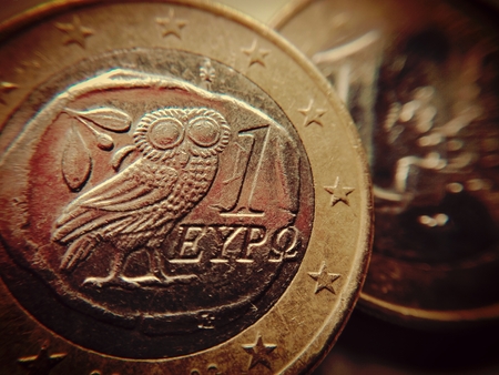 The owl of wisdom on a one euro coin - A Greek euro coin with the Athenian owl,の写真素材
