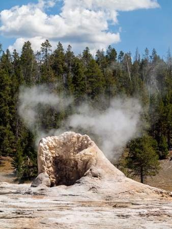 Giant Geyser steams between eruptions in Yellowstone National park's Upper Geyser Basin.の写真素材
