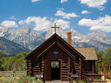The Chapel of the Transfiguration is a small log church built with a window behind the altar to frame the Cathedral Group of Wyomingの写真素材