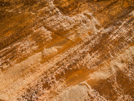 The rugged texture of a sandstone canyon wall is photographed close in Utah 