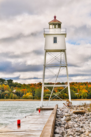 A metal tower lighthouse marks the harbor at Grand Marais on Lake Superior in Michiganの写真素材