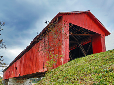 The historic Houck Covered Bridge, built in 1880, crosses Big Walnut Creek in rural Putnam County Indiana.の写真素材