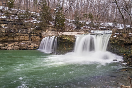 Water spills over Upper Cataract Falls, a waterfall in Owen County, Indiana, as late winter snow melts into spring.の写真素材
