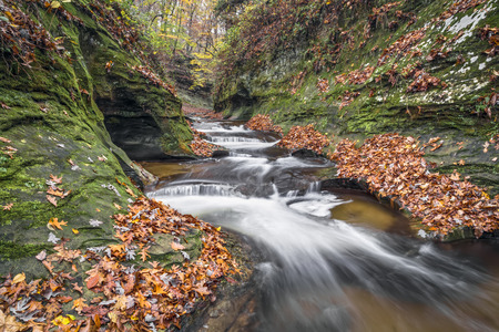 Water cascades down The Potholes, a series of rocky ledges eroded by swirling currents in Fall Creek Gorge, Warren County, Indiana.の写真素材