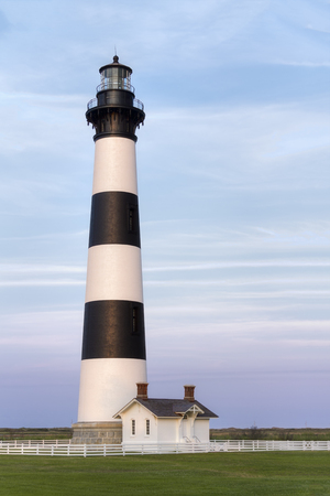 The historic Bodie Island Lighthouse stands tall with white and black stripes at Cape Hatteras National Seashore on the Outer Banks of North Carolina.の写真素材