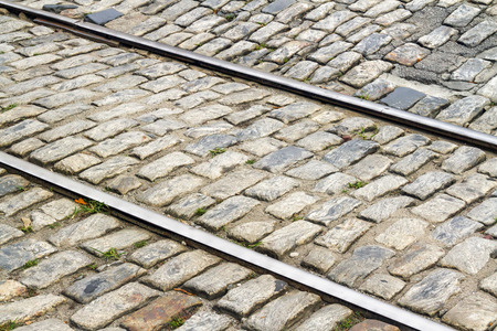 Railroad tracks cross through an old stone street in Savannah, Georgia.の写真素材