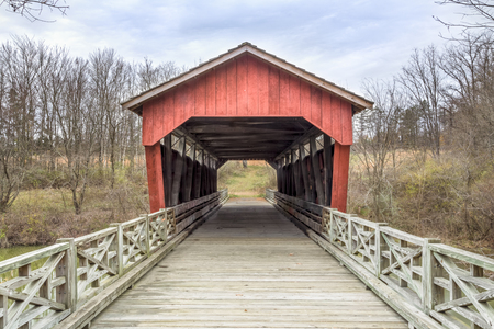 The historic Shaeffer Campbell Covered Bridge cross College Pond on a campus in St. Clairsville, Ohio.の写真素材