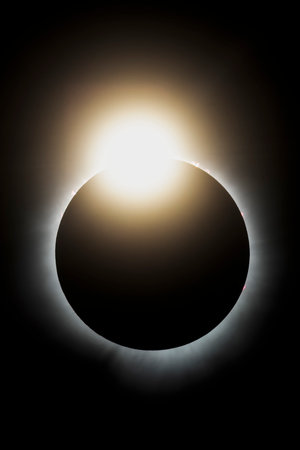 The last light from the sun peaks out before it is completely covered by the moon during the total...