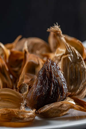 The black garlic is finished by cooking fresh and delicious garlic.の写真素材
