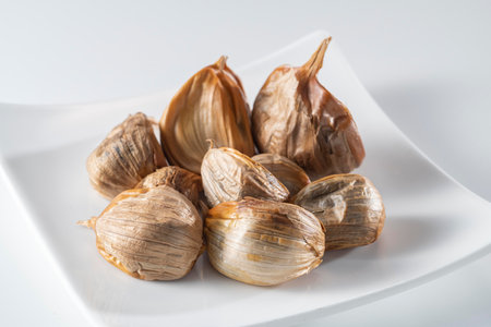 The black garlic is finished by cooking fresh and delicious garlic.の写真素材