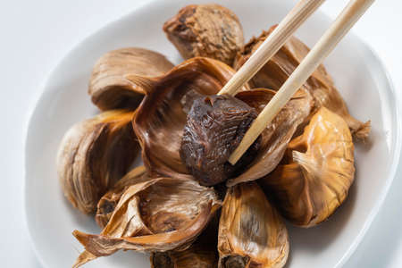The black garlic is finished by cooking fresh and delicious garlic.の写真素材